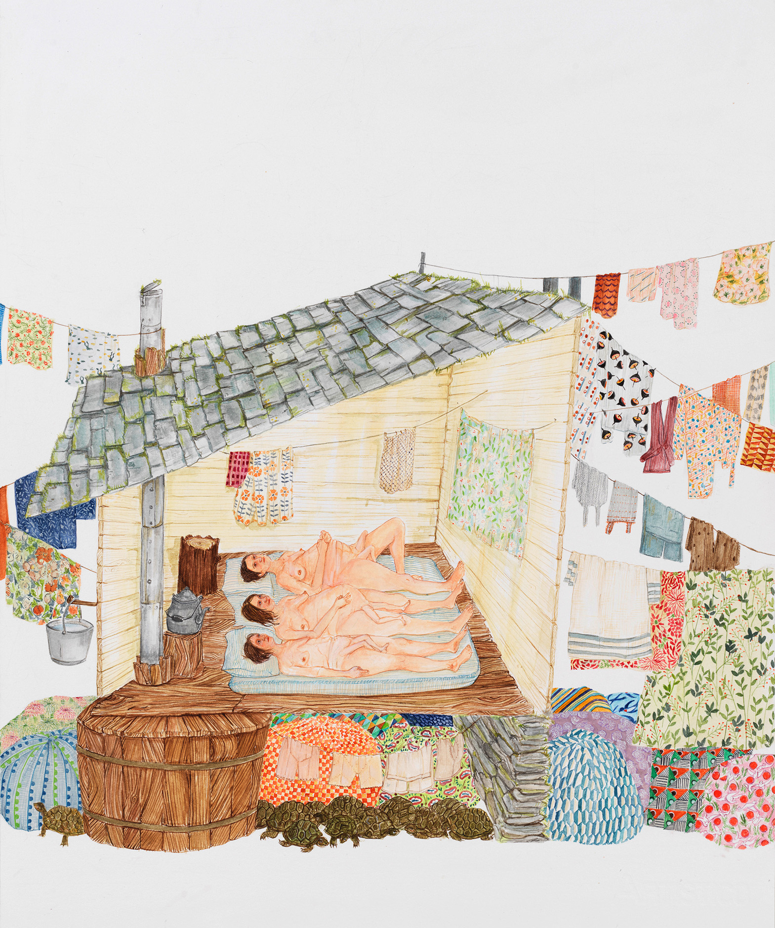Three women lying on a mattress inside a house