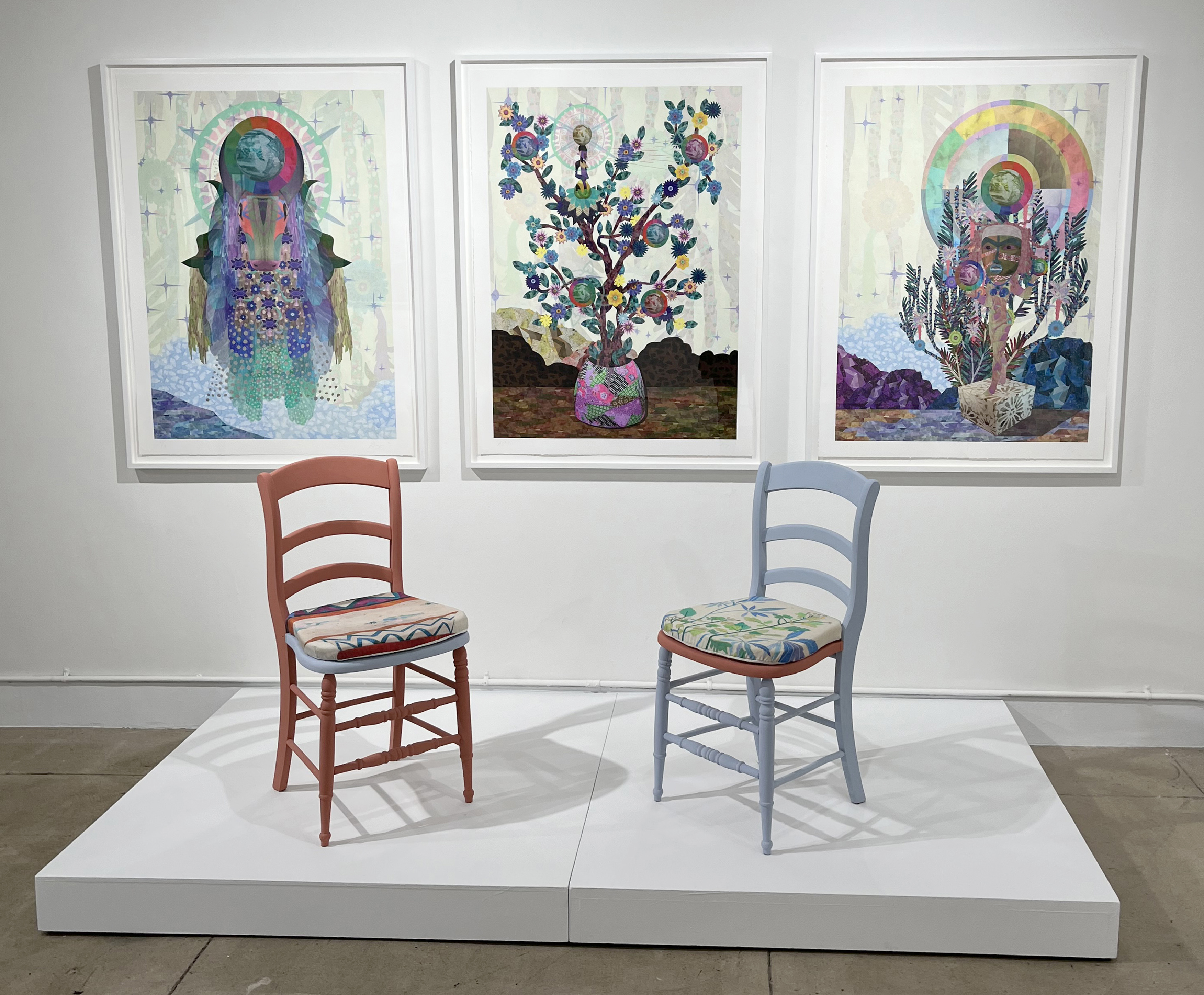 installation view with two chairs and framed prints