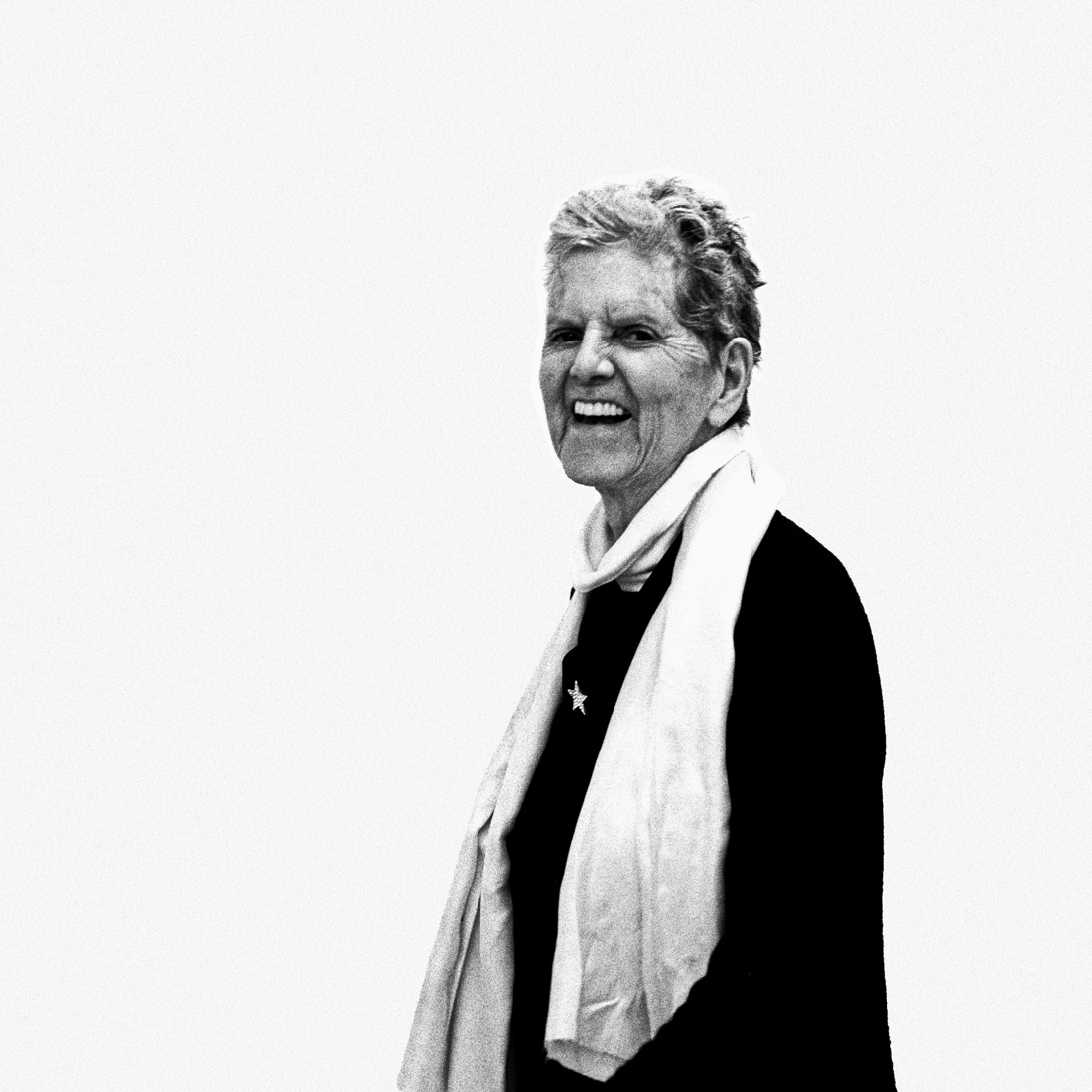 Elaine Sturtevant with white scarf laughing into the camera