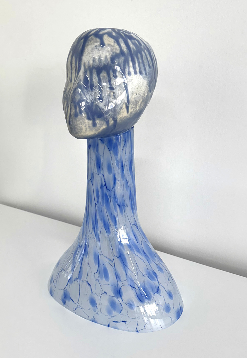 Ceramic bust with glass head covered with blue paint