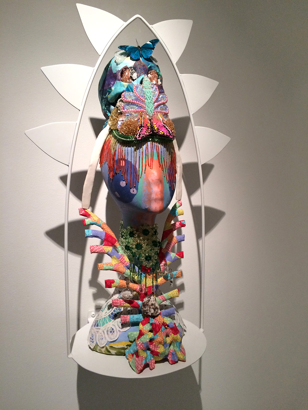 mixed media sculpture of two heads with butterfly